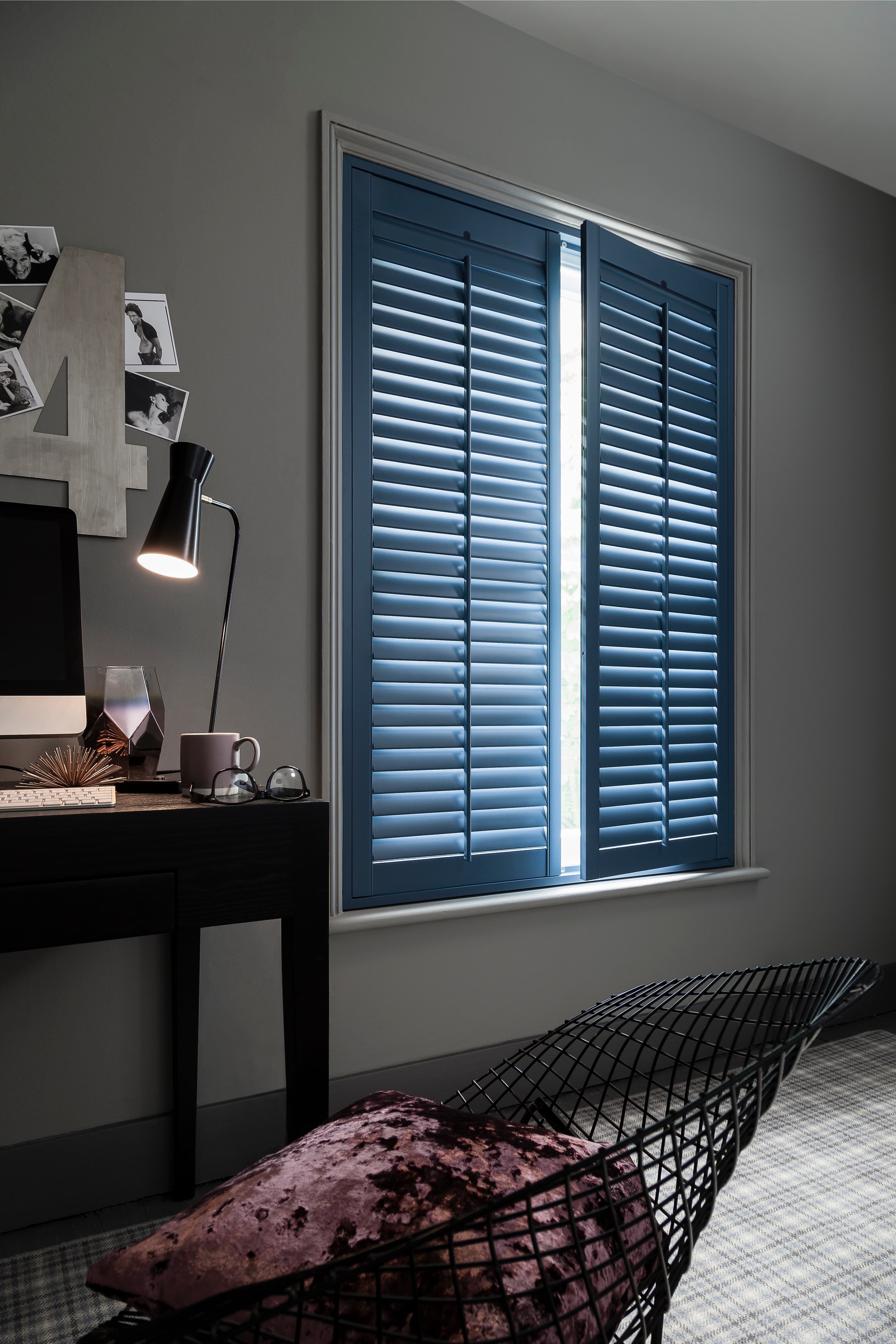 Painted blue shutters in a lounge window