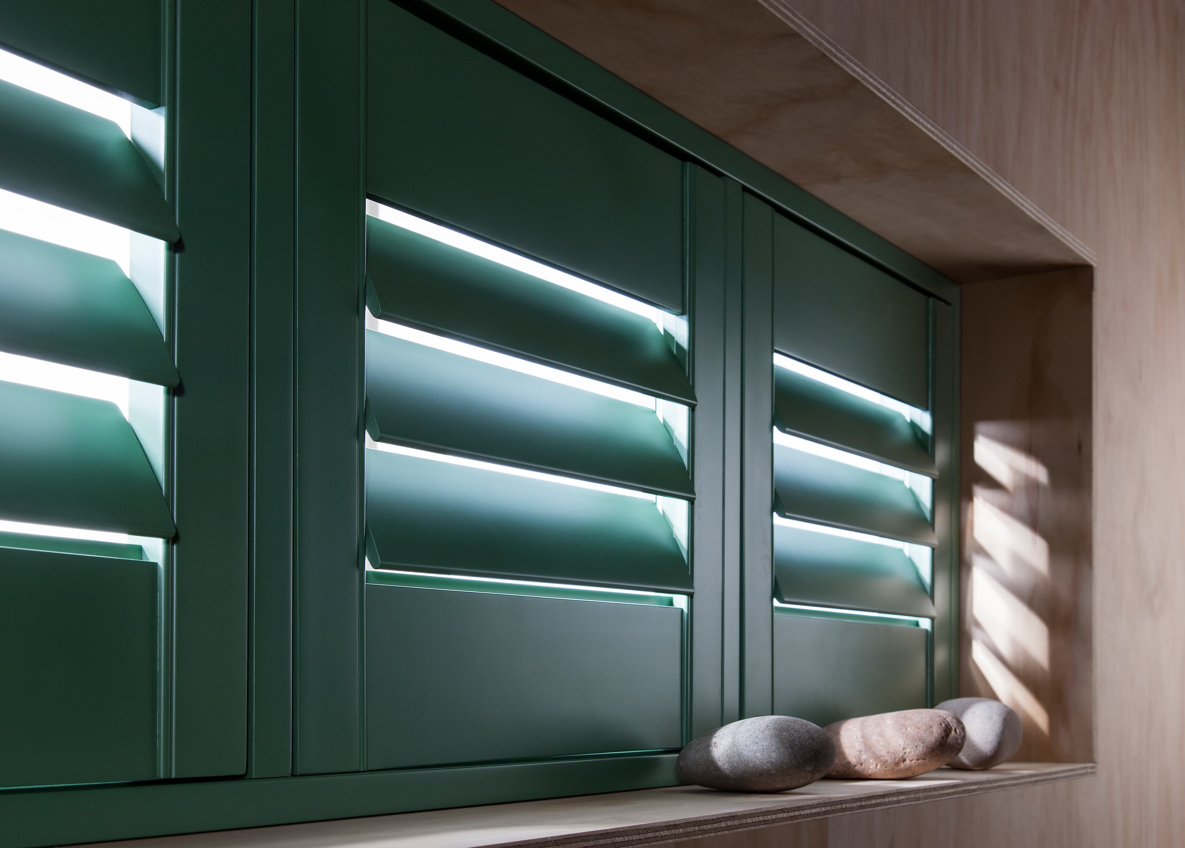 Painted green shutters in a bright room